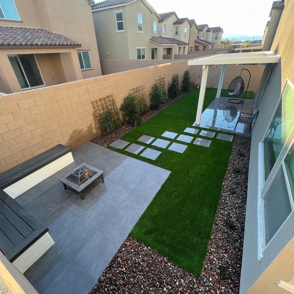 Finished yard with pavers, turf and a fire feature